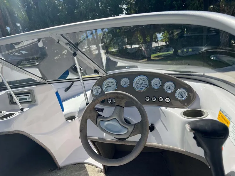 Slide: The Image of 2005 Tahoe T18 Ski Boat dashboard with steering wheel and gauges. - 10