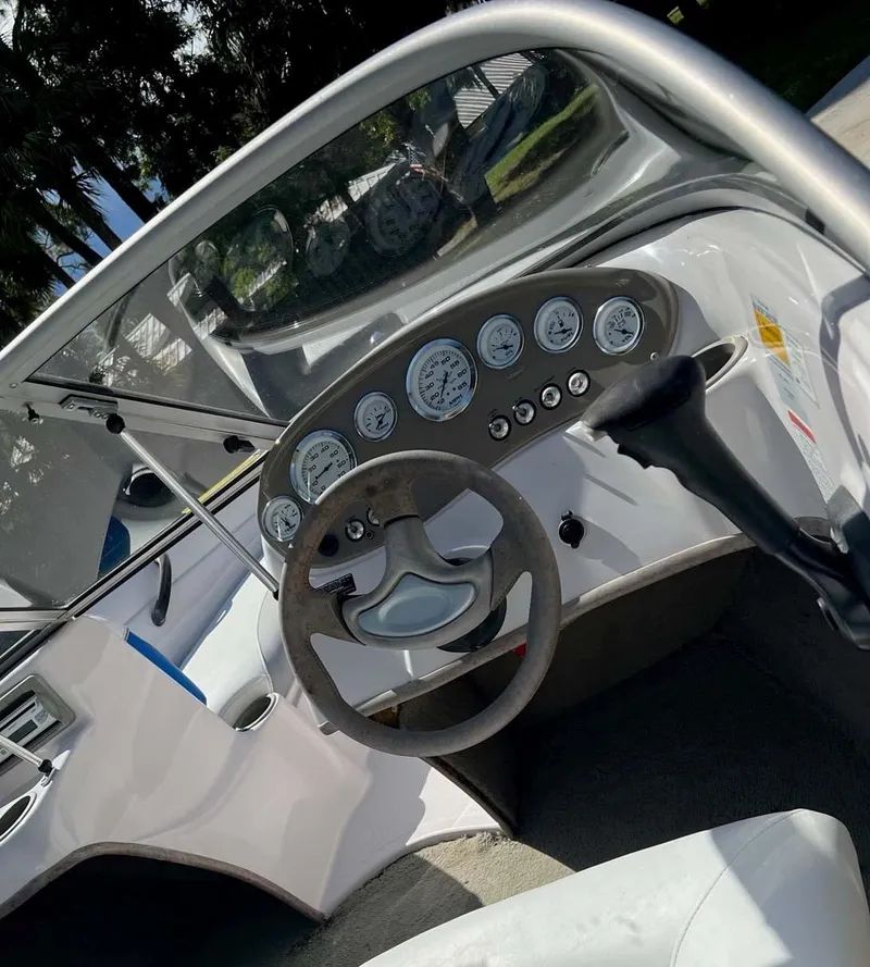 Slide: The Image of 2005 Tahoe T18 Ski Boat dashboard with steering wheel and gauges. - 11
