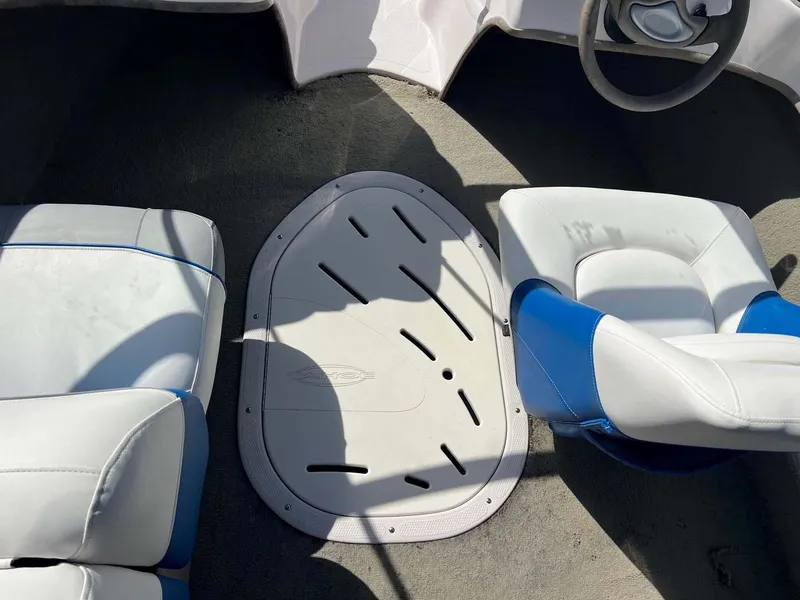 Slide: The Image of 2005 Tahoe T18 Ski Boat interior with white and blue seating. - 8