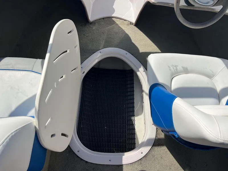 Slide: The Image of 2005 Tahoe T18 Ski Boat interior with open storage compartment and seating. - 9