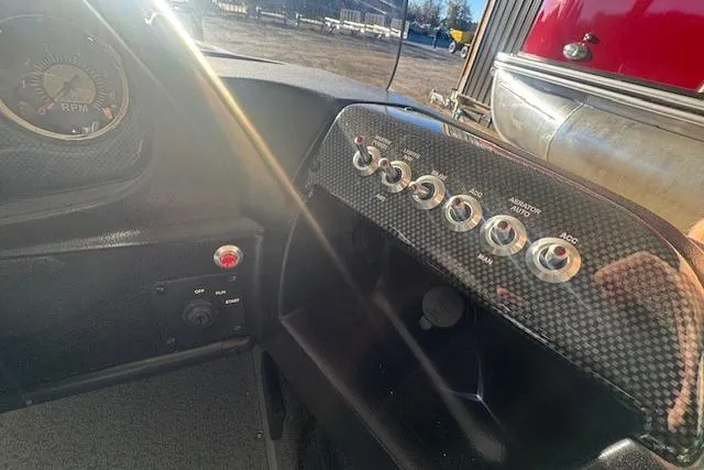 Slide: The Image of Dashboard of a 2026 Lowe Fishing Machine 1625SC with control switches and RPM gauge. - 12