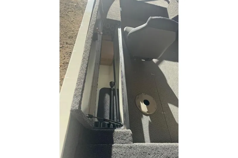 Slide: The Image of 2026 Lowe Fishing Machine 1625SC interior with storage compartment and seating. - 18