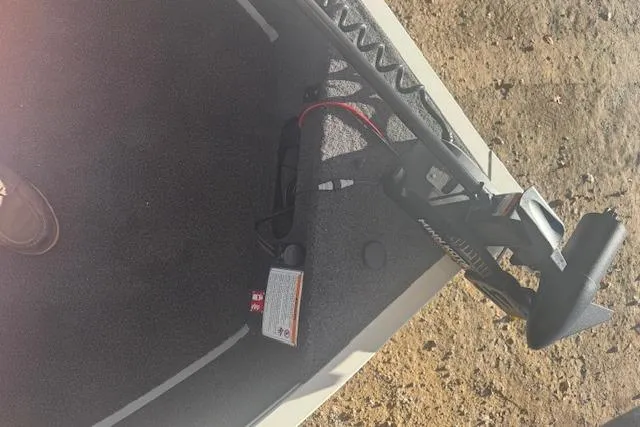 Slide: The Image of 2026 Lowe Fishing Machine 1625SC interior with trolling motor and carpeted floor. - 21