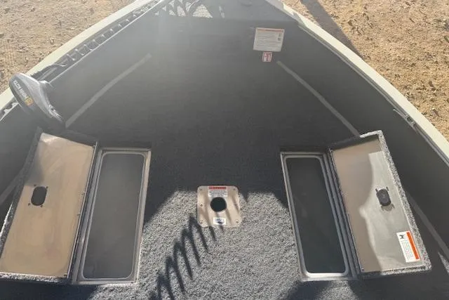 Slide: The Image of 2026 Lowe Fishing Machine 1625SC boat interior with storage compartments open. - 22