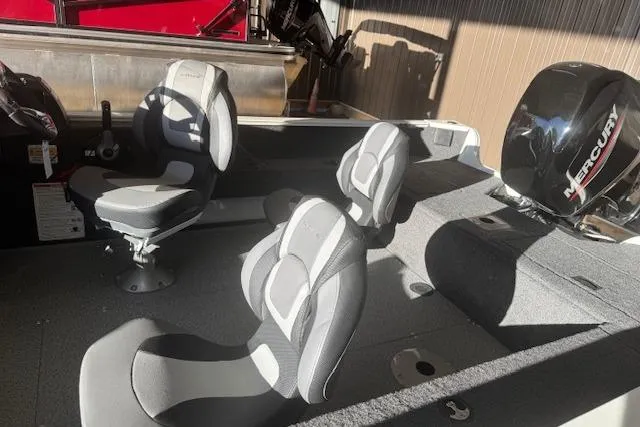 Slide: The Image of 2026 Lowe Fishing Machine 1625SC interior with seating and Mercury outboard motor. - 23