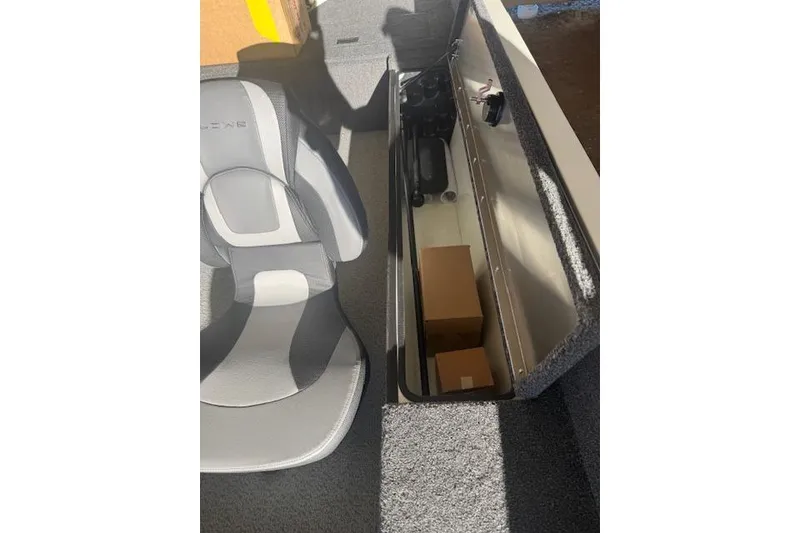 Slide: The Image of 2026 Lowe Fishing Machine 1625SC interior with storage compartment and seat. - 24