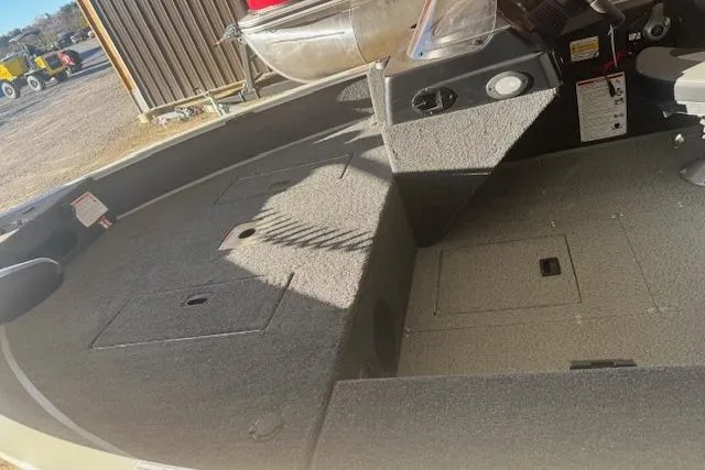 Slide: The Image of 2026 Lowe Fishing Machine 1625SC interior with storage compartments and seating. - 25