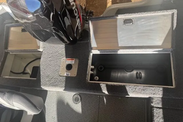 Slide: The Image of 2026 Lowe Fishing Machine 1625SC interior with storage compartments and Mercury engine. - 26