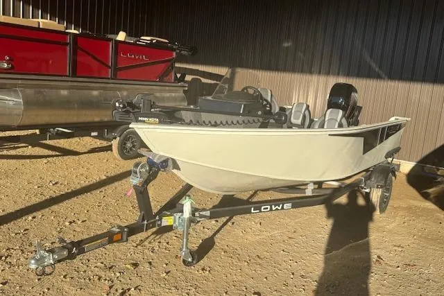 Slide: The Image of 2026 Lowe Fishing Machine 1625SC boat on trailer, parked outdoors. - 6