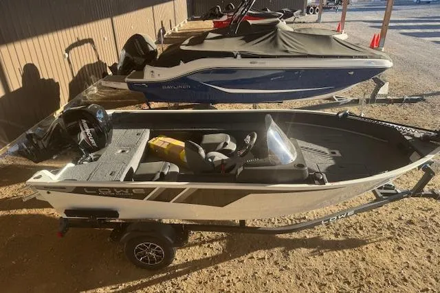 Slide: The Image of 2026 Lowe Fishing Machine 1625SC boat on trailer, parked outdoors. - 7