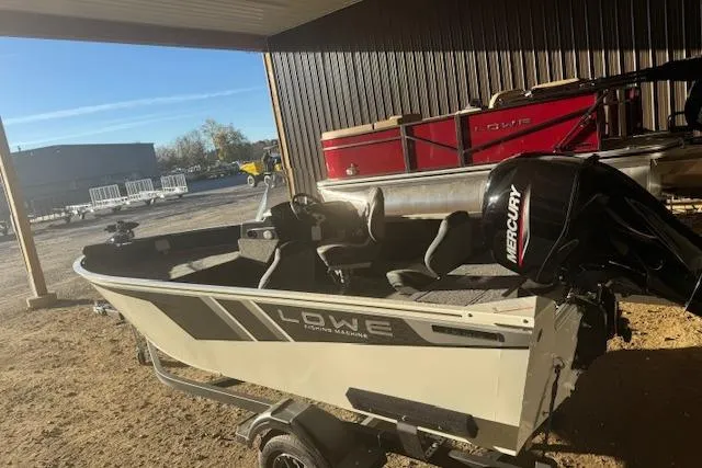 Slide: The Image of 2026 Lowe Fishing Machine 1625SC boat with Mercury engine, parked outdoors. - 8