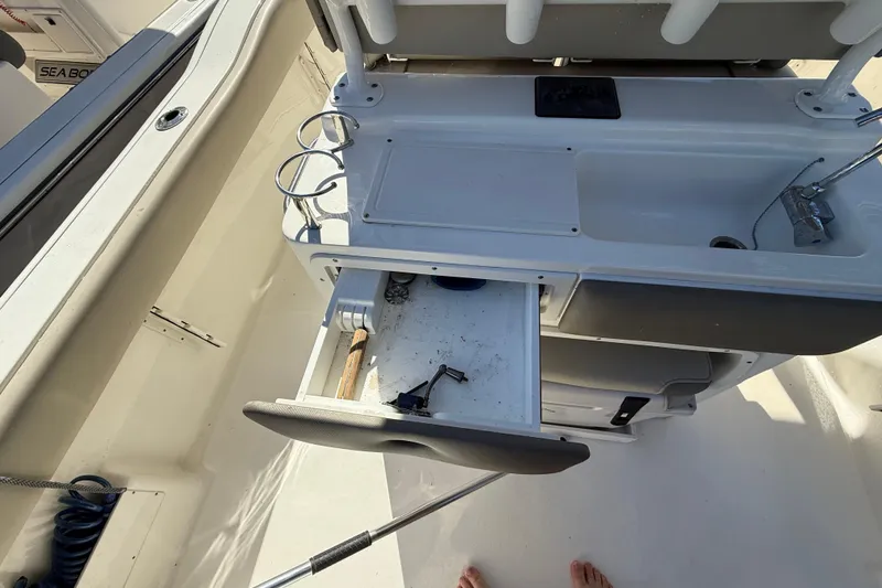 Slide: The Image of 2021 Key West 239 FS boat interior with open storage drawer and sink area. - 17