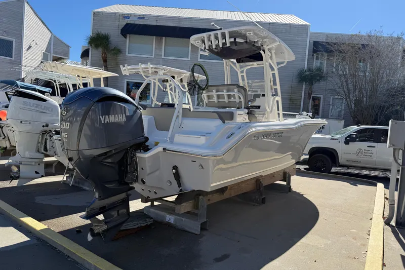 Slide: The Image of 2021 Key West 239 FS boat with Yamaha engine displayed outdoors. - 2