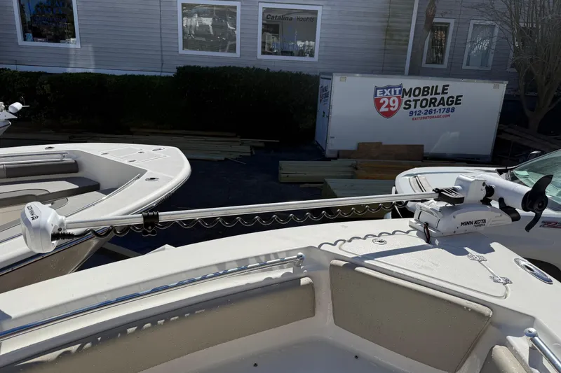 Slide: The Image of 2021 Key West 239 FS boat with Minn Kota trolling motor, parked near storage facility. - 21