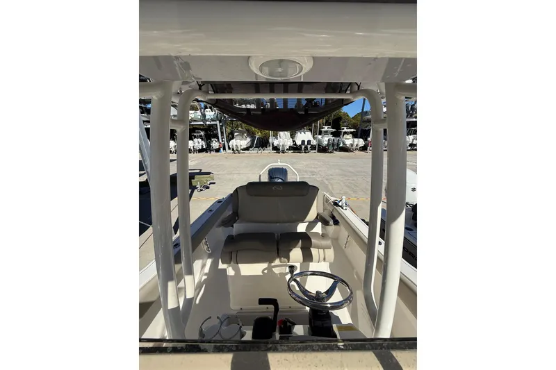 Slide: The Image of 2021 Key West 239 FS boat interior with steering wheel and seating area. - 22