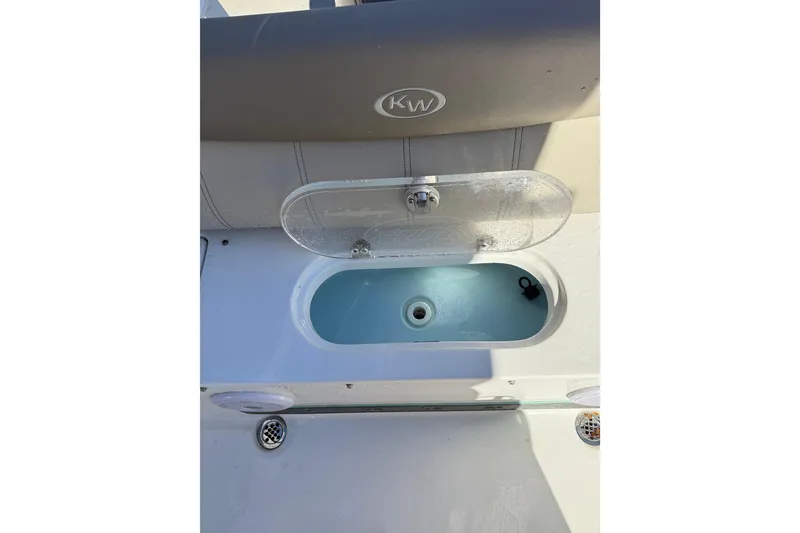 Slide: The Image of 2021 Key West 239 FS boat livewell with open lid and seating area. - 25