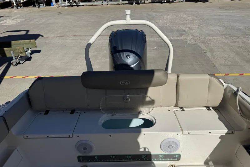 Slide: The Image of 2021 Key West 239 FS boat interior with seating and engine view. - 27
