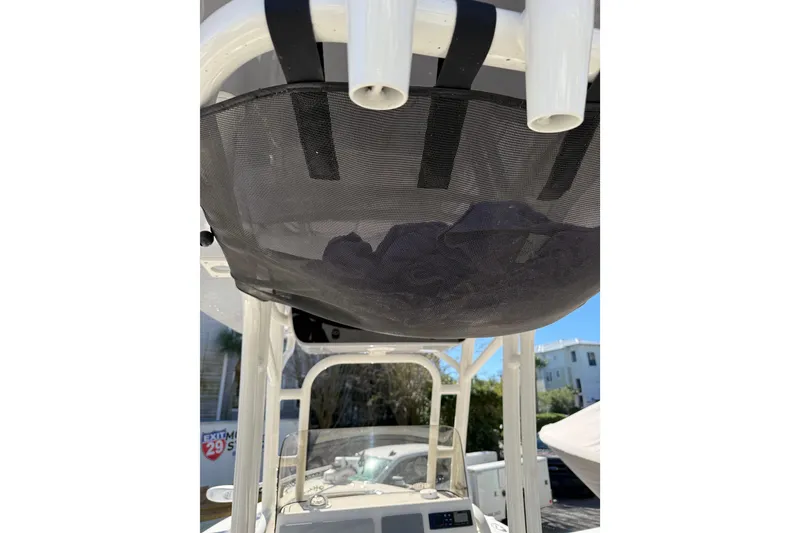 Slide: The Image of 2021 Key West 239 FS boat with overhead storage net and rod holders. - 28