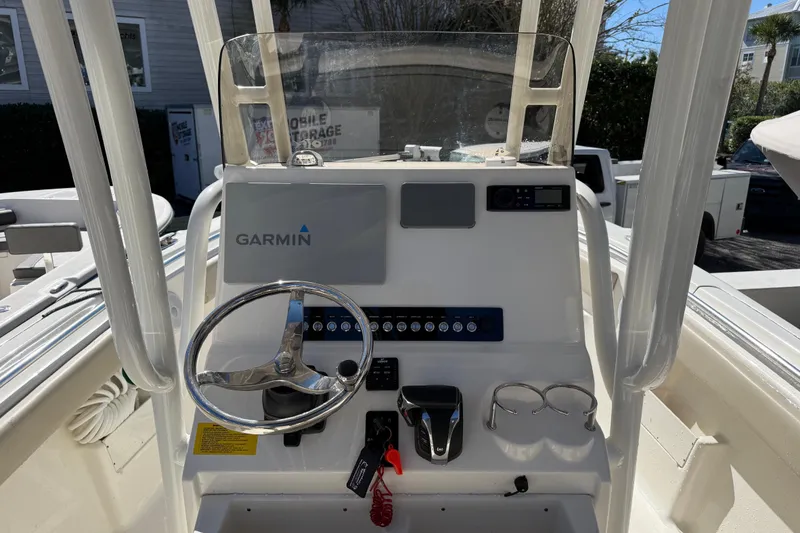Slide: The Image of 2021 Key West 239 FS boat console with Garmin navigation system and steering wheel. - 6