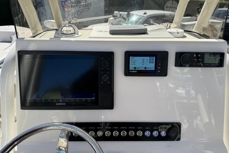 Slide: The Image of 2021 Key West 239 FS boat dashboard with Garmin and Yamaha displays. - 8