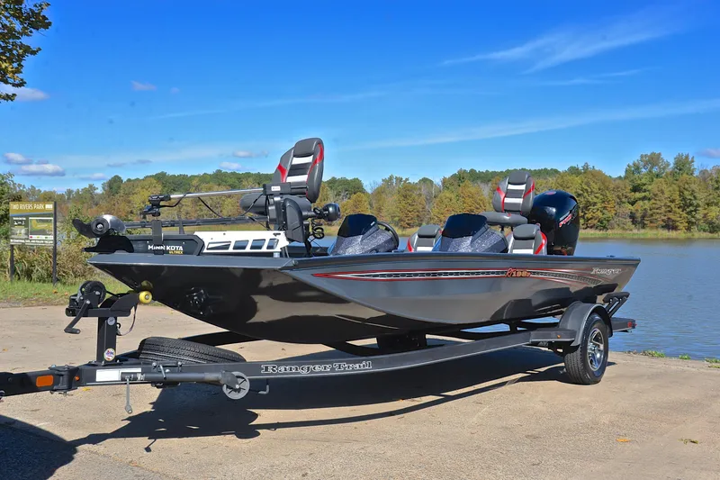 Slide: The Image of 2022 Ranger RT198P boat on trailer by lake, clear sky, trees in background. - 10