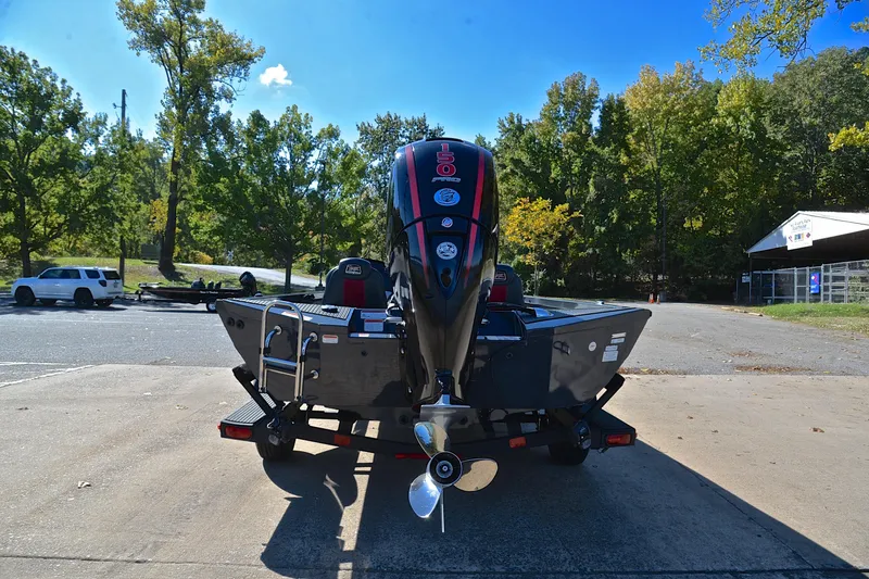Slide: The Image of 2022 Ranger RT198P boat with 150 horsepower engine, parked outdoors on a sunny day. - 13