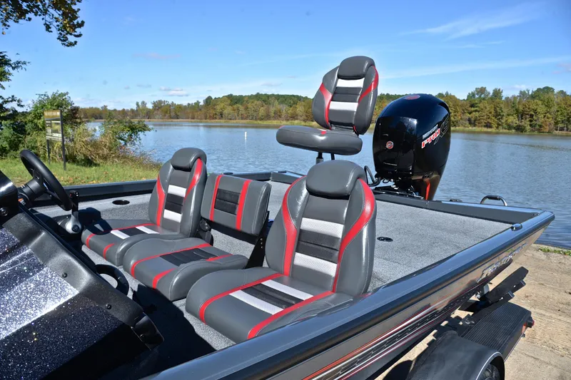 Slide: The Image of 2022 Ranger RT198P boat with stylish seating, docked by a scenic lake. - 18