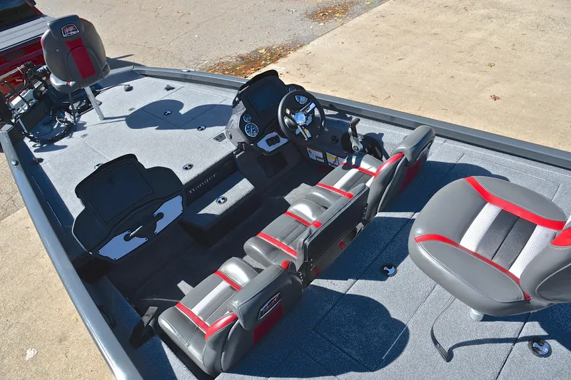 Slide: The Image of 2022 Ranger RT198P boat interior with gray and red seating, steering console, and storage compartments. - 22
