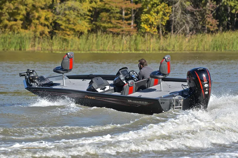 Slide: The Image of 2022 Ranger RT198P boat cruising on a lake with lush greenery in the background. - 6
