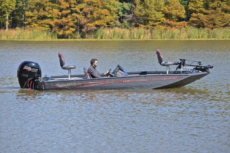 Slide: The Image of 2022 Ranger RT198P boat on a lake with a person driving, surrounded by autumn trees. - 7