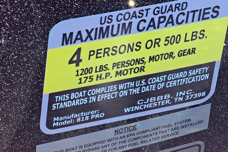 Slide: The Image of US Coast Guard capacity label on 2026 Phoenix 818 Pro boat, 4 persons or 500 lbs. - 20