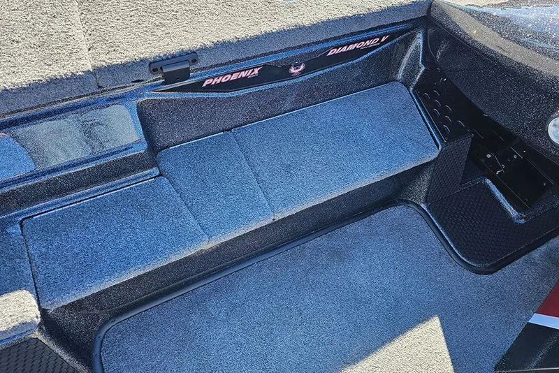 Slide: The Image of 2026 Phoenix 818 Pro boat interior with gray carpet and storage compartments. - 23