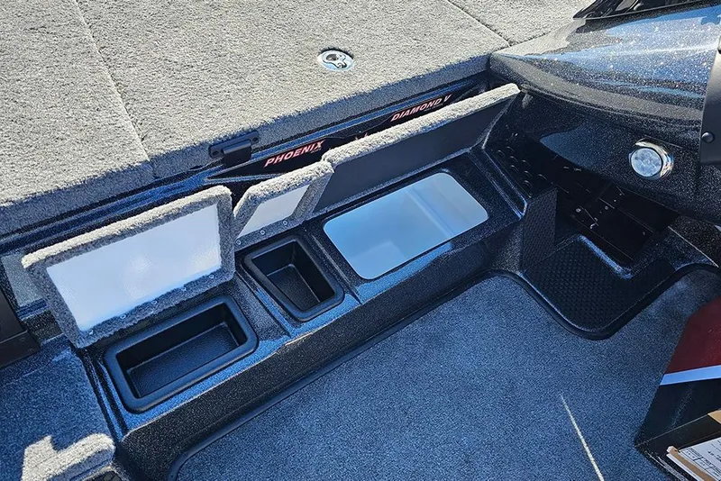 Slide: The Image of Interior of 2026 Phoenix 818 Pro boat with storage compartments and carpeted flooring. - 24