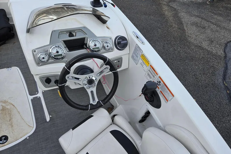 Slide: The Image of Steering console of a 2018 Tahoe 2150 boat with gauges and controls. - 11