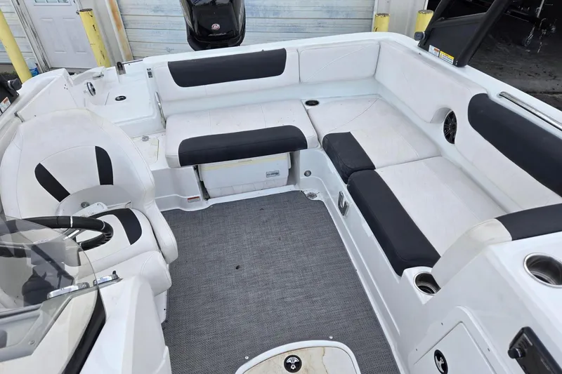 Slide: The Image of 2018 Tahoe 2150 boat interior with black and white seating and gray carpet. - 12