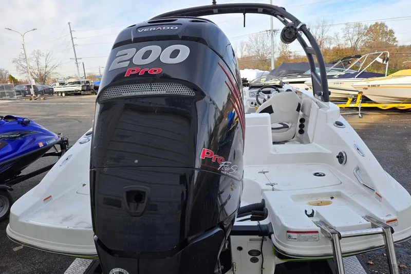 Slide: The Image of 2018 Tahoe 2150 boat with a 200 Pro Verado engine, parked outdoors. - 5