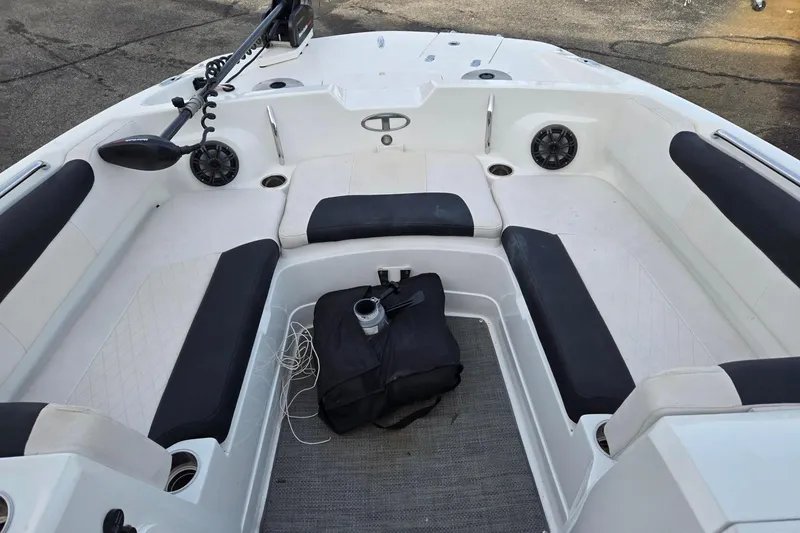 Slide: The Image of 2018 Tahoe 2150 boat interior with black and white seating, speakers, and accessories. - 7