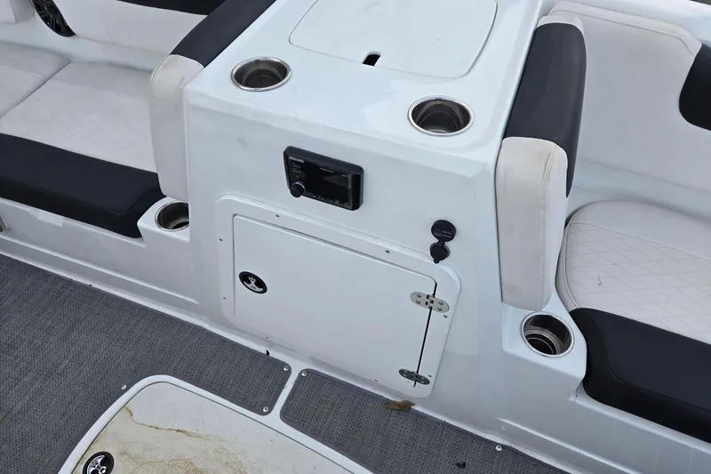 Slide: The Image of 2018 Tahoe 2150 boat interior with cup holders and seating. - 8