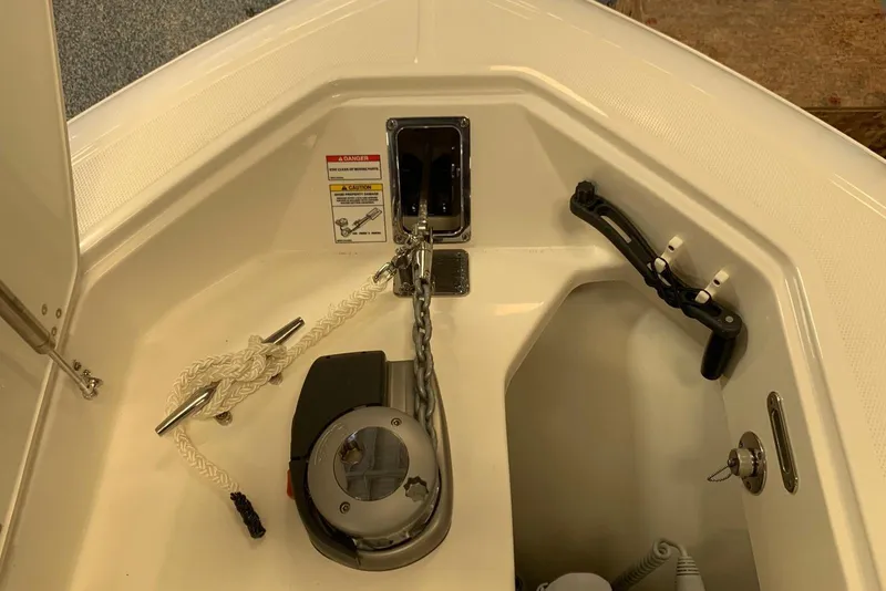 Slide: The Image of 2019 Boston Whaler 330 Outrage anchor compartment with chain and rope setup. - 16