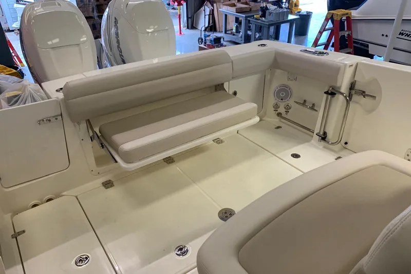 Slide: The Image of 2019 Boston Whaler 330 Outrage boat interior with seating and storage compartments. - 9