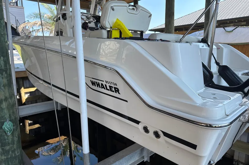 The Image of 2023 Boston Whaler 230 Outrage boat docked, showcasing sleek design and modern features. - 0