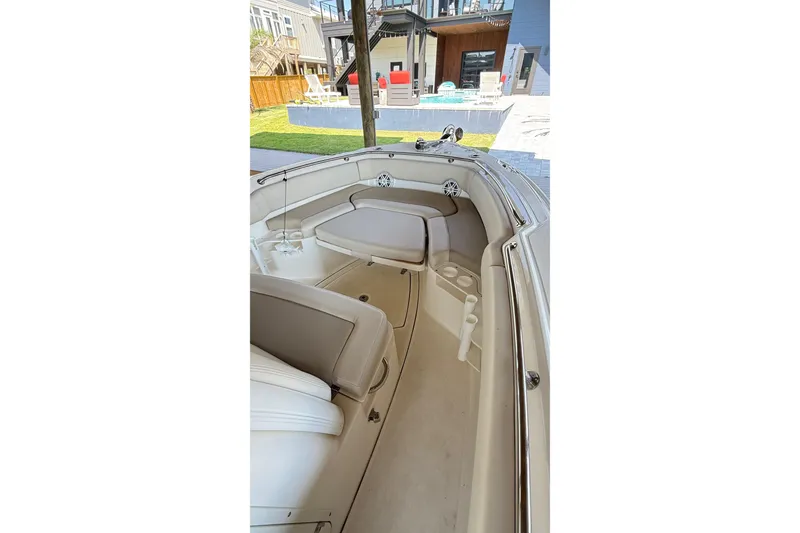 Slide: The Image of 2023 Boston Whaler 230 Outrage boat interior with seating and cup holders. - 10