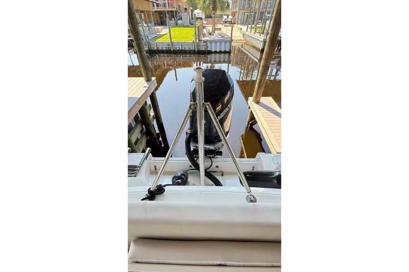 Slide: The Image of 2023 Boston Whaler 230 Outrage docked, rear view with outboard motor. - 16