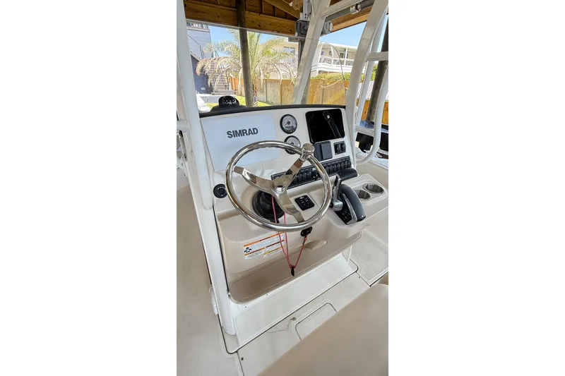 Slide: The Image of 2023 Boston Whaler 230 Outrage boat console with Simrad navigation system. - 2