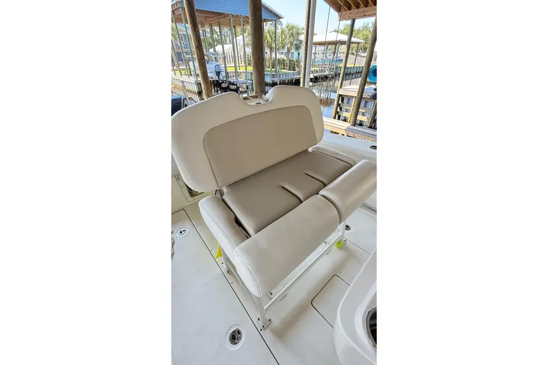 Slide: The Image of 2023 Boston Whaler 230 Outrage boat seat, beige upholstery, docked at marina. - 5