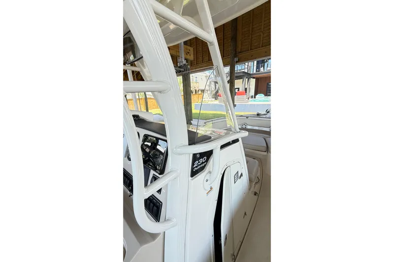Slide: The Image of 2023 Boston Whaler 230 Outrage boat interior with console and seating. - 7