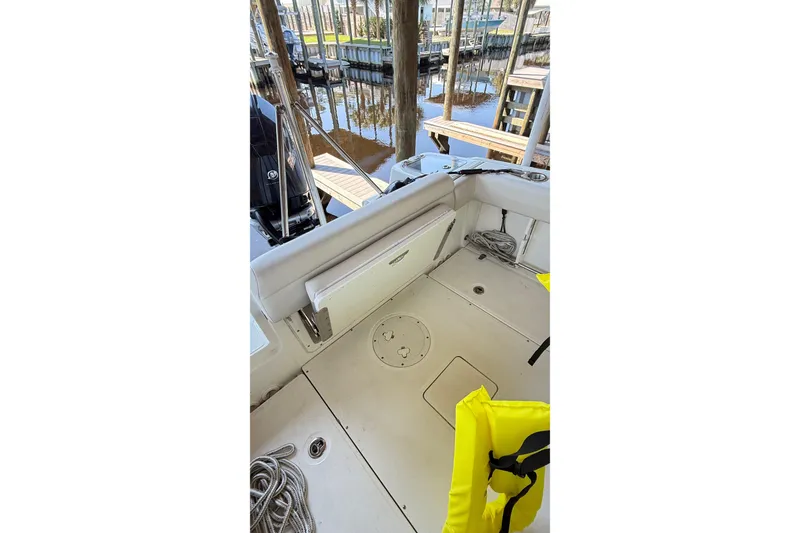 Slide: The Image of 2023 Boston Whaler 230 Outrage boat interior with seating, ropes, and life jacket. - 8