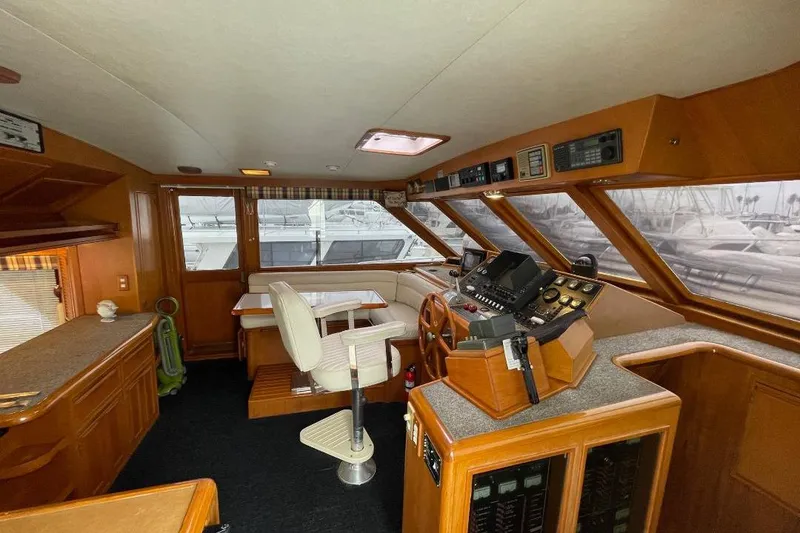 Slide: The Image of 1990 Offshore Yachts 55 Pilothouse interior with helm, seating, and navigation equipment. - 12