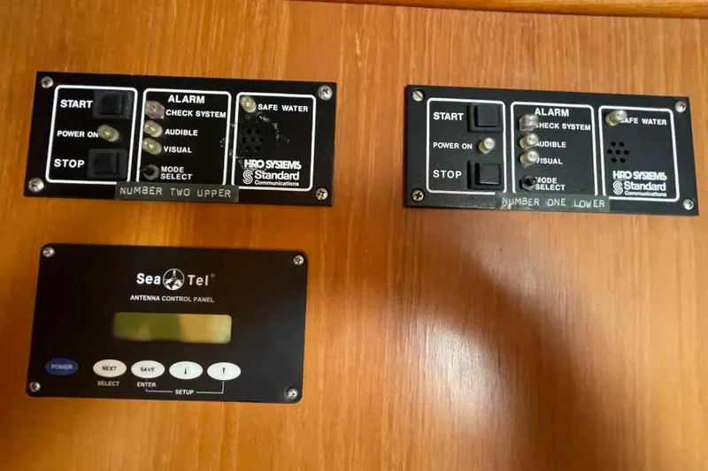 Slide: The Image of Control panels on a 1990 Offshore Yachts 55 Pilothouse, featuring alarm and antenna systems. - 14