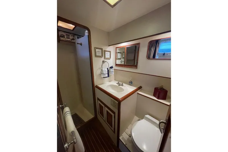 Slide: The Image of Bathroom interior of 1990 Offshore Yachts 55 Pilothouse, featuring shower, sink, and toilet. - 19